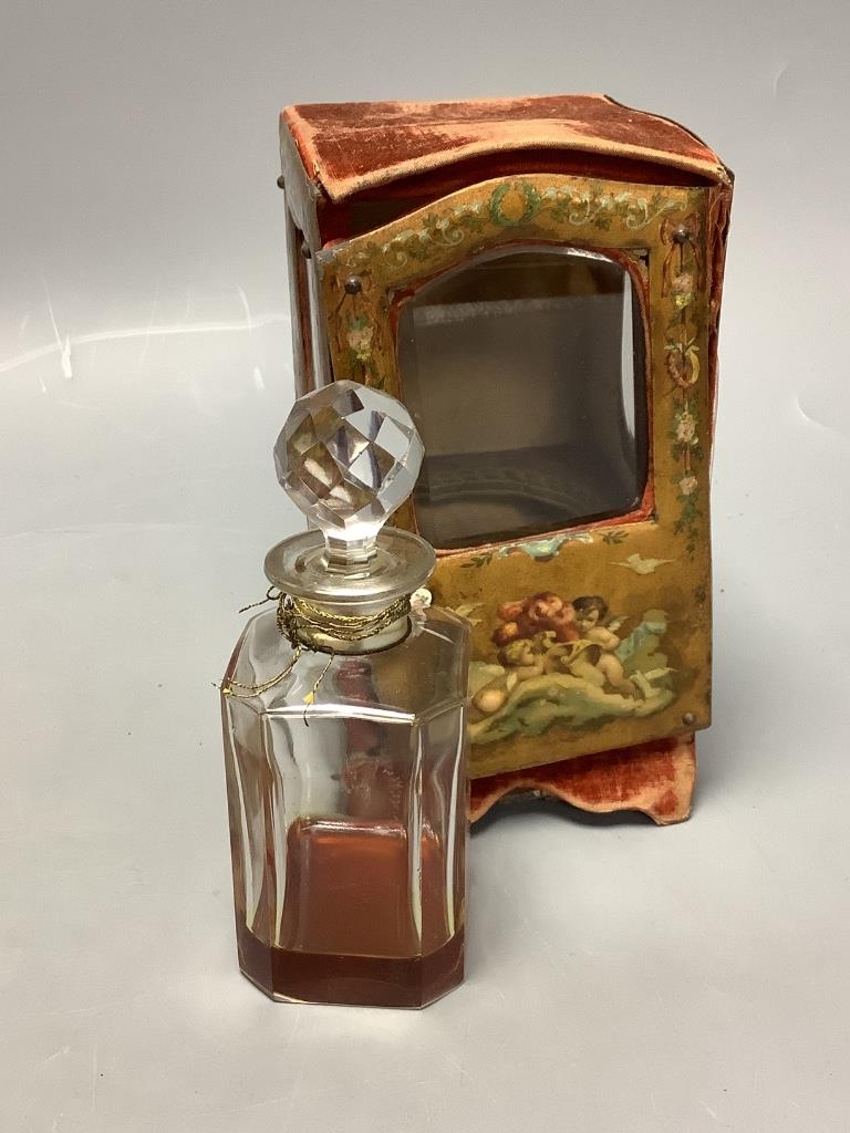 A papier mache and velvet ‘sedan chair’ scent bottle case, associated bottle and a Flore d’Argent eau de cologne bottle